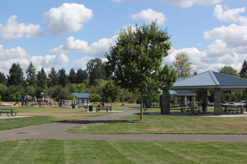 park gree with picnic shelters and playground equipment