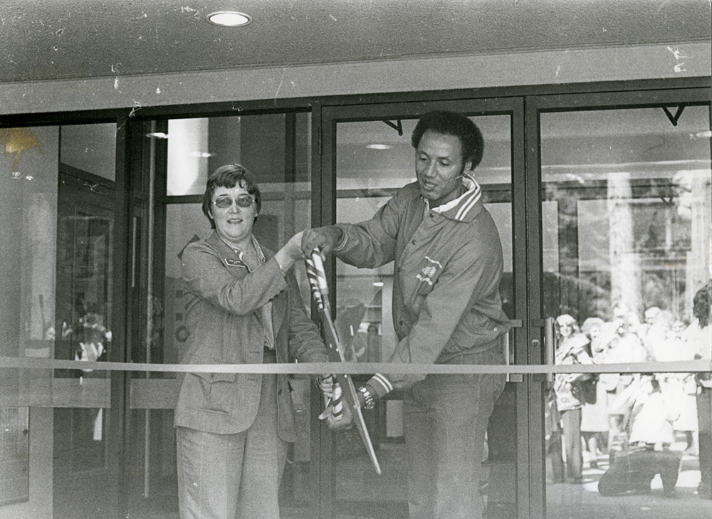 two people cutting a ribbon at the city center dedication in 1979