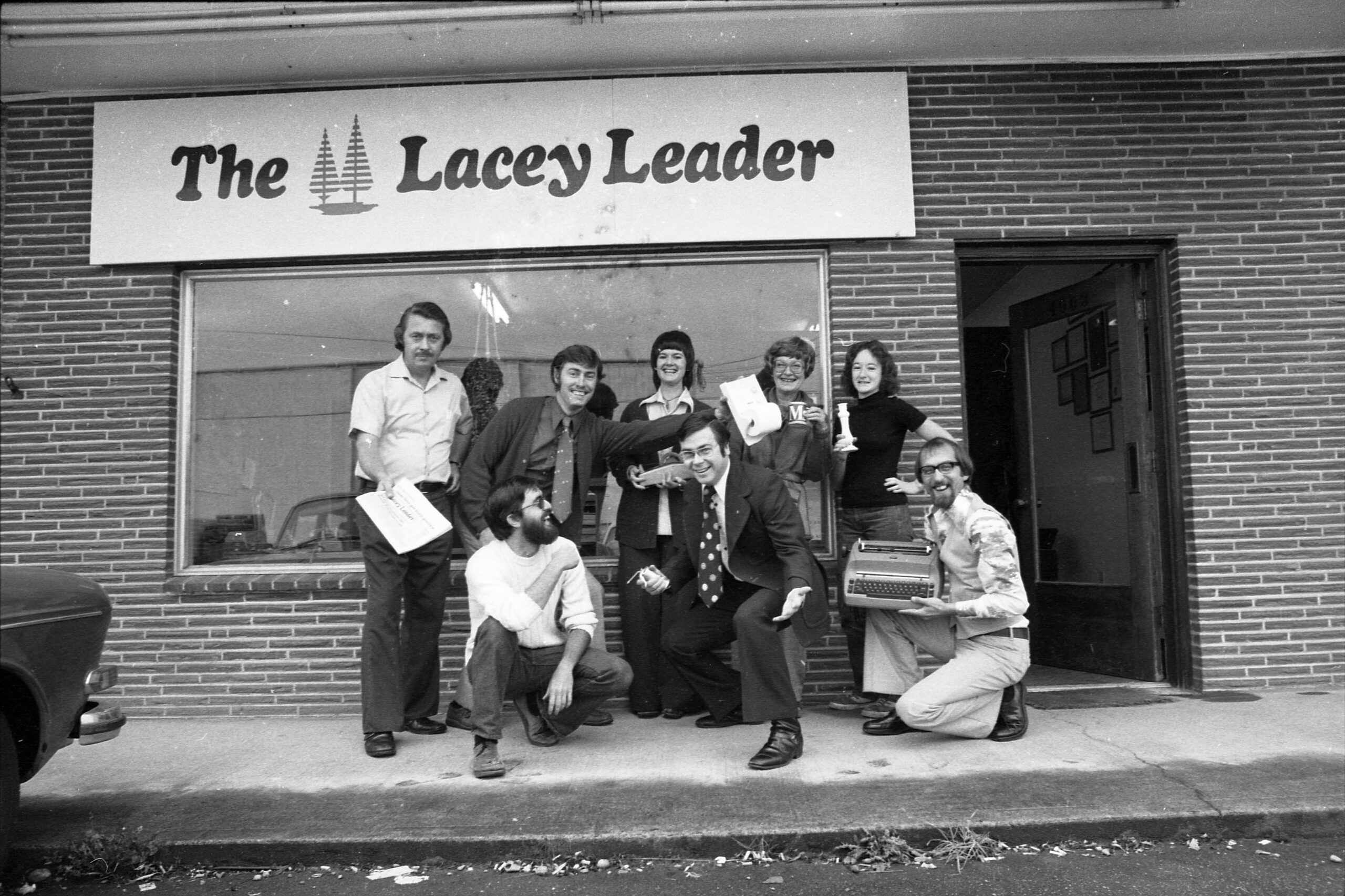 staff outside of the lacey leader building sign