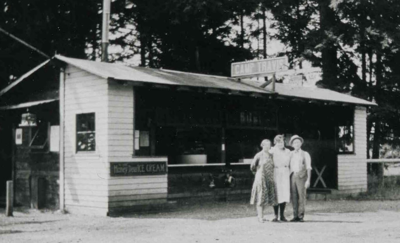 people standing in front of a building at camp travis