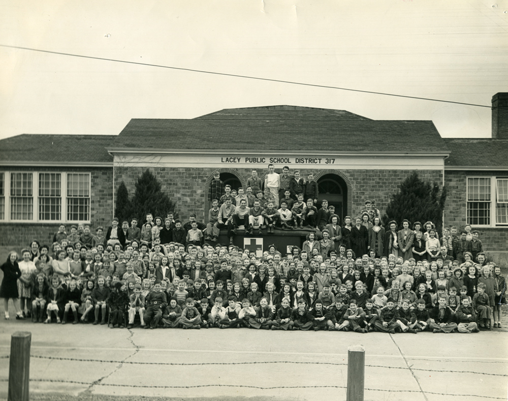 Lacey school building with the entire student body in front, 1943
