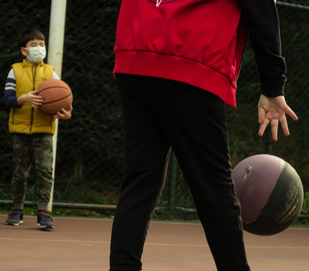 kids in masks playing basketball