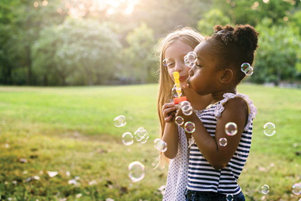 little girls blowing bubbles
